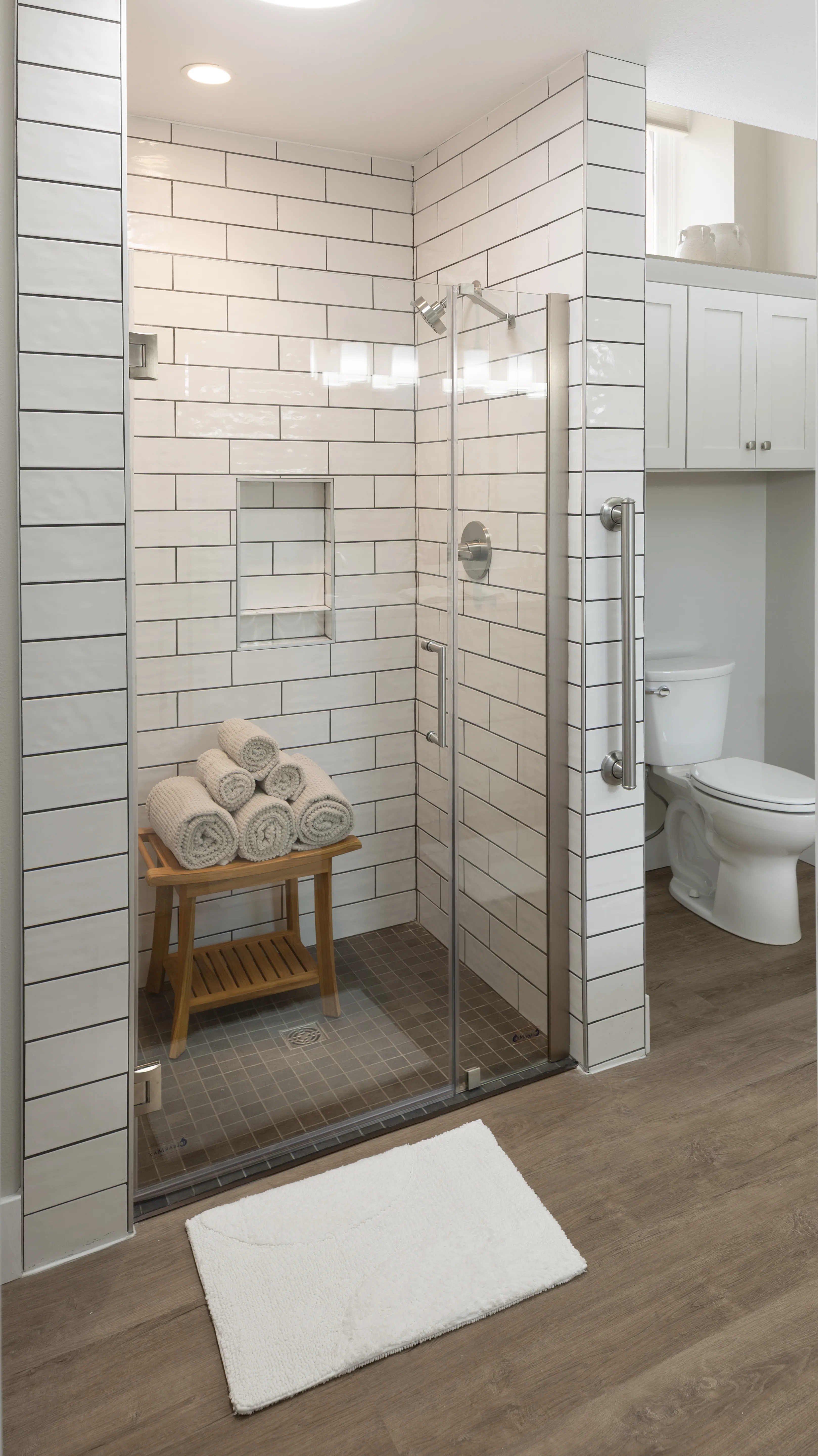 Spacious, tiled shower with a high nozzle and higher ceilings